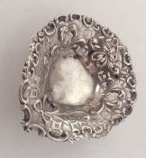 A small silver embossed heart shaped bonbon dish.