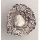 A small silver embossed heart shaped bonbon dish.