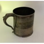 A Georgian silver tapering mug with reeded decorat