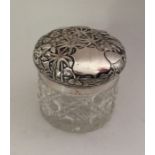 A heavy silver mounted dressing table jar decorate