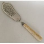 A George III silver fish slice with ivory handle.