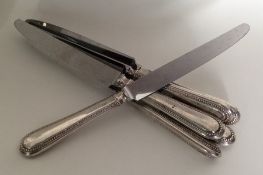 A set of six silver handled bead edged knives with
