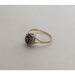 An amethyst and diamond circular cluster ring. App