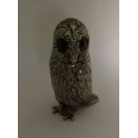 A novelty white metal model of an owl with texture