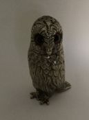 A novelty white metal model of an owl with texture