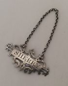 A pierced silver wine label for 'Sherry' on suspen