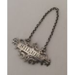 A pierced silver wine label for 'Sherry' on suspen