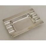 A silver Art Deco ashtray with engine turned decor