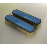 A good pair of silver and enamelled hairbrushes en