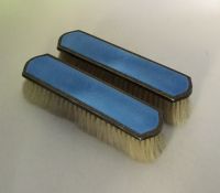 A good pair of silver and enamelled hairbrushes en