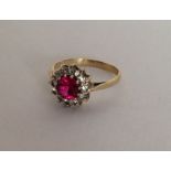 An attractive circular cluster ring in 9 carat mou