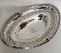 A large Georgian oval silver swing handled cake ba