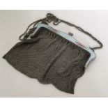 A large silver mesh handbag with blue, green and p