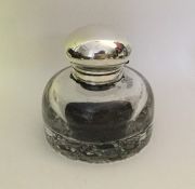 A large silver hinged top cylindrical glass inkwel