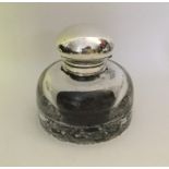 A large silver hinged top cylindrical glass inkwel