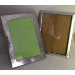 Two plain rectangular silver picture frames with p