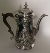 A good Georgian silver embossed tapering coffee po