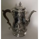 A good Georgian silver embossed tapering coffee po