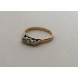 An 18 carat diamond three stone ring in claw mount