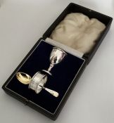 A cased silver egg cup, napkin ring and spoon. App