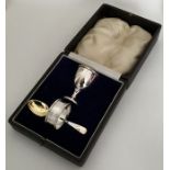 A cased silver egg cup, napkin ring and spoon. App