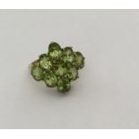 A large 9 carat peridot cluster ring in gold mount
