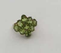 A large 9 carat peridot cluster ring in gold mount