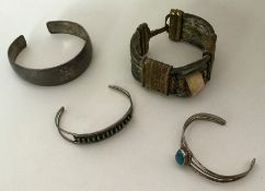 A silver mounted bangle together with three others