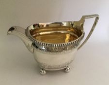 A good quality Georgian silver cream jug with gilt