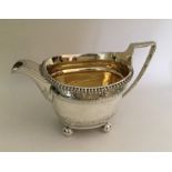 A good quality Georgian silver cream jug with gilt