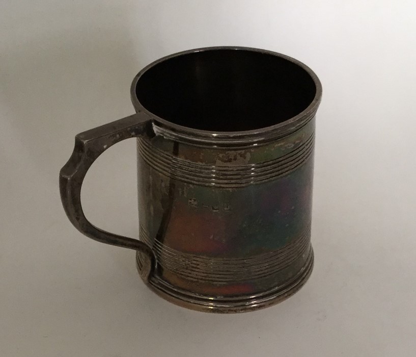 A small Georgian silver mug with reeded decoration