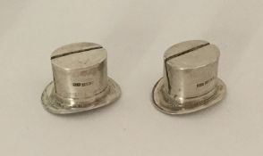 A pair of unusual silver menu holders in the form