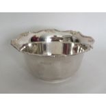 An Edwardian silver sugar bowl with shaped edge. S