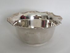 An Edwardian silver sugar bowl with shaped edge. S
