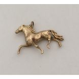 An unusual 9 carat pendant in the form of a gallop