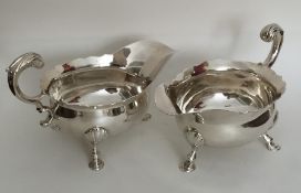 A heavy pair of large Georgian silver sauce boats