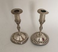 A pair of Antique silver circular candlesticks wit