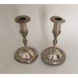 A pair of Antique silver circular candlesticks wit