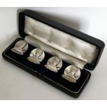 A rare set of four silver menu holders in the form