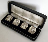 A rare set of four silver menu holders in the form