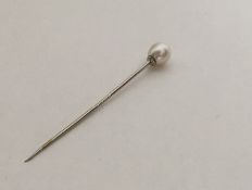 A single stone pearl mounted as a pin with twisted