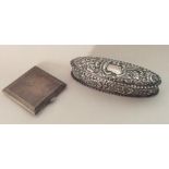 A stylish silver compact together with a chased ov