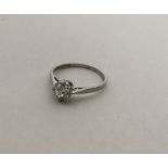 A small platinum single stone diamond ring in claw