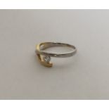 An 18 carat two colour gold single stone ring of a