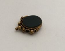 A large gold blood stone set spinning fob with loo