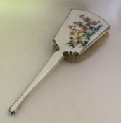 An attractive silver and enamelled hairbrush depic