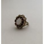 A 9 carat opal and garnet cluster ring. Approx. 4.