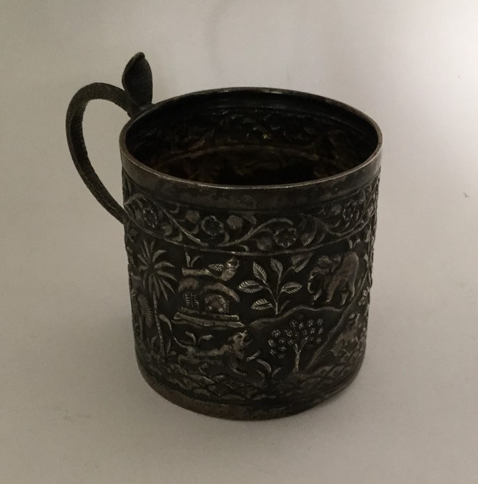 A heavy Indian silver mug decorated with animals. - Image 2 of 2