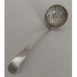 An Edwardian silver sifter spoon with pierced bowl
