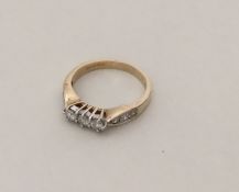 A 9 carat diamond three stone ring in gold mount.